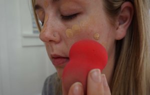 applying foundation with beauty blender