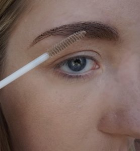 applying clear eyebrow gel