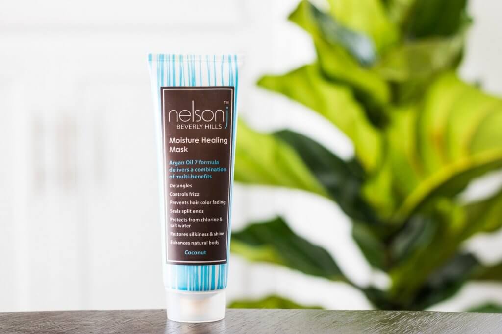 nelson j moisture healing mask in front of green plant